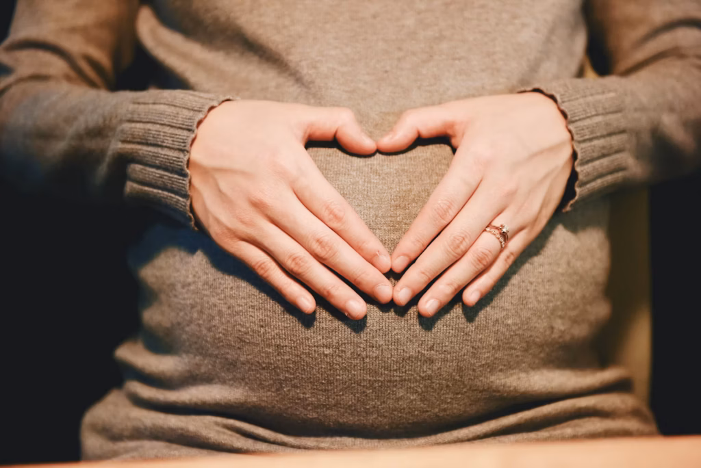 mother hands on belly, white background